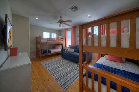 Bedroom 4 features two twin-over-twin bunk beds, a queen-size sleep sofa, and a TV.