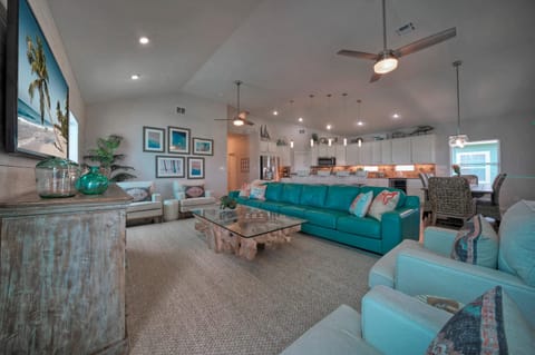 Living space greeting you with a super long & cool teal sofa.