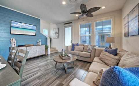 Living room features comfortable seating and a TV.