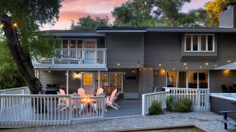 Inviting backyard patio with firepit, grill, and string lights.