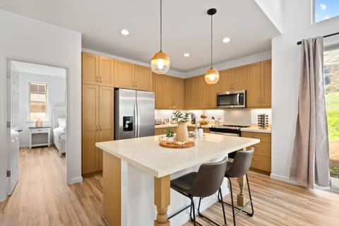 Fully equipped kitchen with barstool seating.