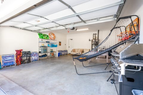 Garage features a basketball game and beach supplies.