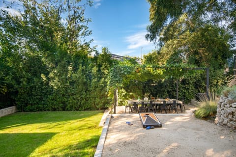 Spacious lawn area and cornhole.