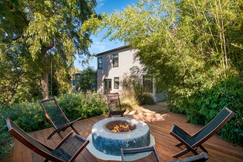 Spacious backyard features a propane firepit.