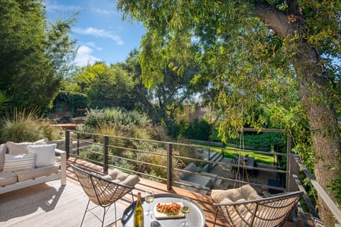 Balcony features seating and overlooks the rest of the backyard.