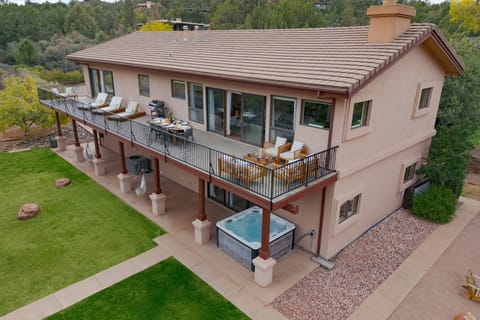 Multiple ways to enjoy the views and outdoors, including a balcony, patio, hot tub, and lawn.