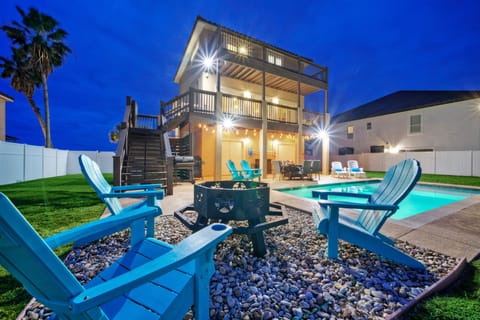 Outdoor oasis with a pool, firepit, and lounge space.