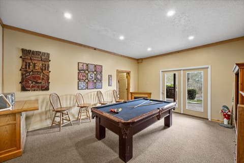 Lower level game room with ping pong topper and a pool table.