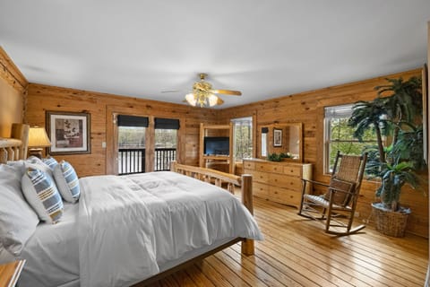 Primary Bedroom features a king bed with a private balcony, bathroom, and a TV.