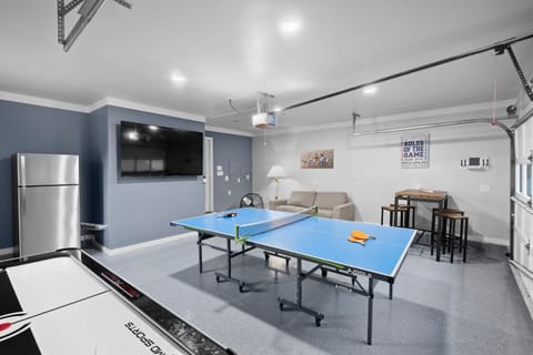 Converted garage into a game room featuring a ping-pong table, air hockey and large TV!