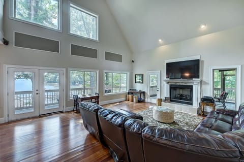 Large great room - floor-to-ceiling windows - great views of the lake and plenty of seating for all, right off the kitchen!