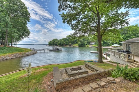 Family Lake House Retreat-built-in fire pit with stone bench seating.