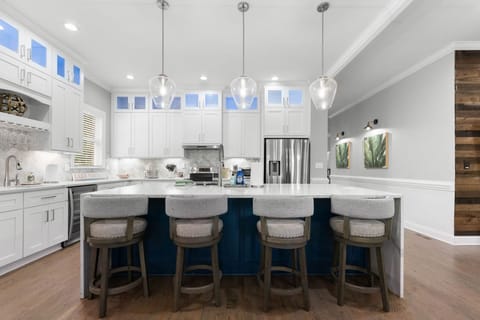 Open space kitchen with new, stainless, appliances.