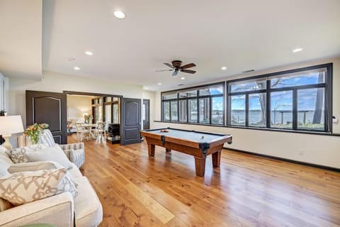 Lower level game room with pool table and large TV.