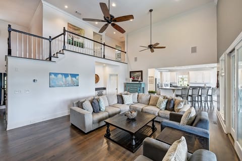 Living room with sectional, two large chairs, sliders to screened in porch & amazing lake views.