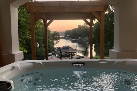 Soak in the hot tub overlooking the serene cove.