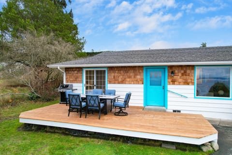 Beautiful deck with ocean views and a firepit table.