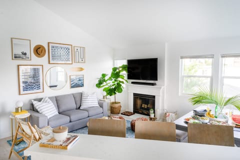 Living room at Sonrisa II features comfortable seating, a fireplace, and a TV.