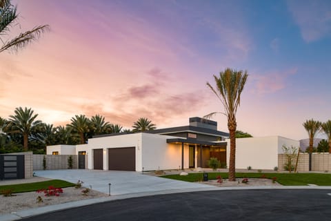 The media room features a comfortable sectional and access to the outdoor pool, spa, and putting green.