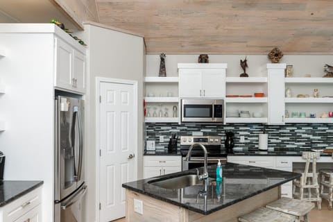 Modern kitchen with an island and barstool seating.