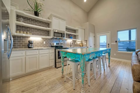 Stunning modern kitchen and chic rustic counter-top table with dining area.