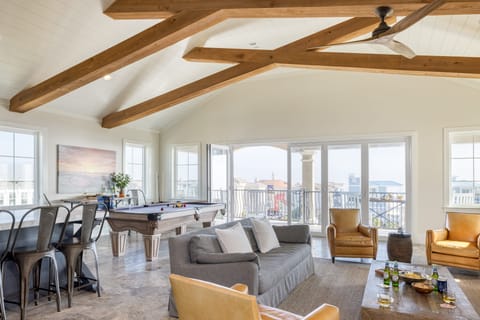 Second living area features a pool table, balcony, and kitchen.