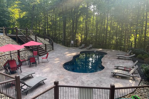 Beautiful community pool surrounded by trees.