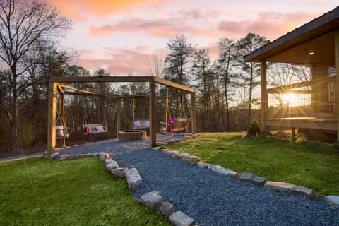 Fire pit surrounded by bench swings.
