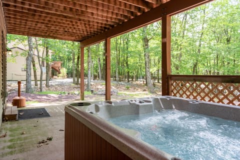 Relax on the covered patio with a hot tub dip.