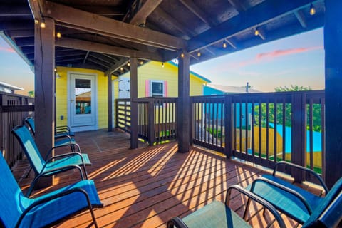 A sun-drenched balcony with seating.