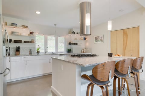 Ample counter space and additional barstool seating in the kitchen.