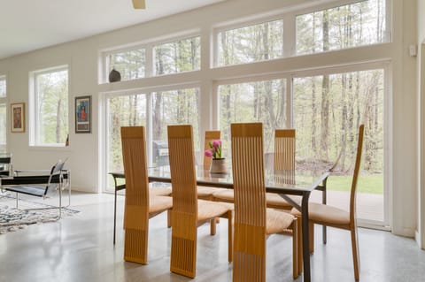 Stylish dining area next to windows overlooking the patio.