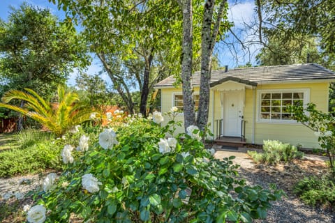 Charming exterior surrounded by vibrant flowers.