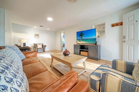 Comfortable chairs and TV setup in the inviting living room.