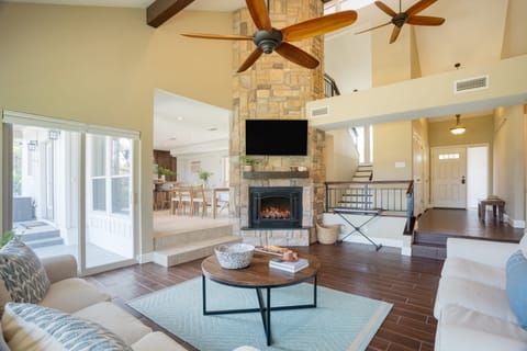 Charming living room with a TV and a cozy fireplace for chilly evenings.