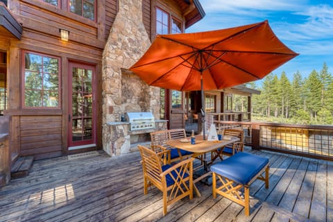 Perfect for outdoor feasts: our deck features a BBQ grill, chairs, tables, and a shady umbrella.