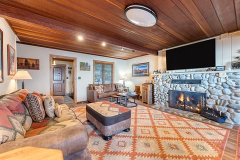 Living area features a cozy stone fireplace.
