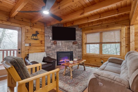 Stone fireplace, fully-equipped ceilings, and an a-frame-inspired design.