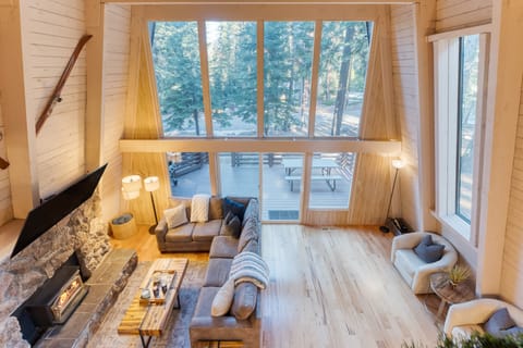 Vaulted ceilings and floor-to-ceiling windows in the living room.