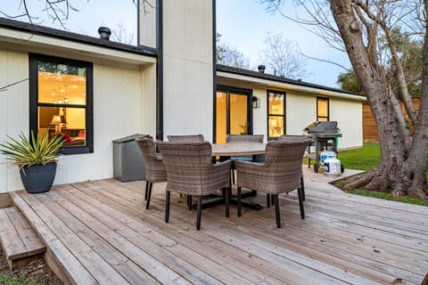 Private patio with an outdoor dining area and BBQ grill.