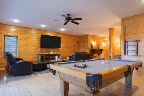 Game room with shuffleboard and a pool table.