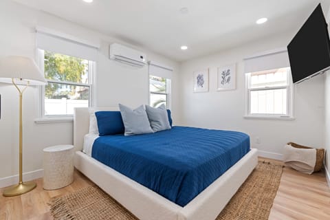 The primary bedroom features a king bed, TV, and an ensuite bathroom.