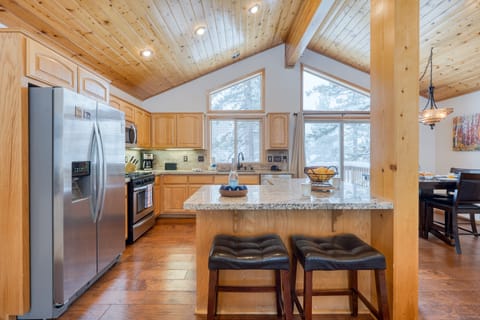 Bright kitchen - high ceilings, large windows, and barstools.