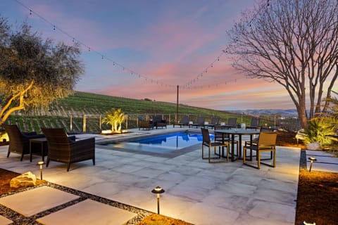 Ultimate outdoor oasis—poolside seating, BBQ, firepit, and multiple dining areas for unforgettable gatherings.
