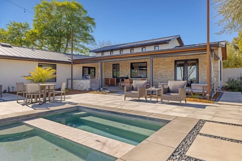 Spacious patio featuring ample seating, a sparkling pool, and a relaxing spa—your perfect outdoor retreat.