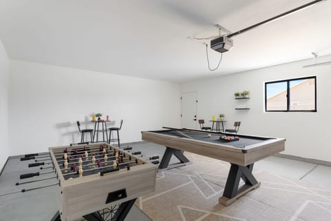 Game room offer a pool table and a foosball table.