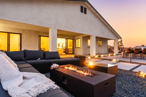Enjoy cozy evenings by the fire with this modern outdoor lounge.