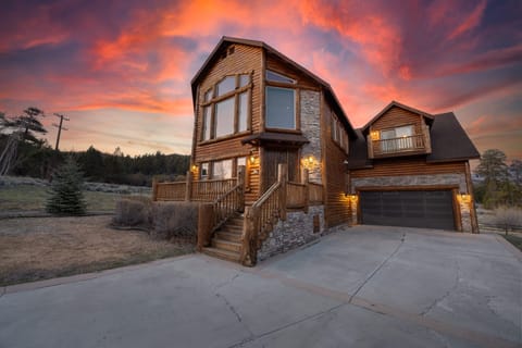 Stunning exterior glows with warmth and curb appeal as day fades to dusk.