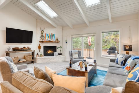 Living room featuring a fireplace, TV, and comfortable seating.
