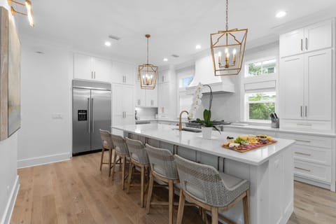 Gourmet kitchen with bar seating and pendant lights.